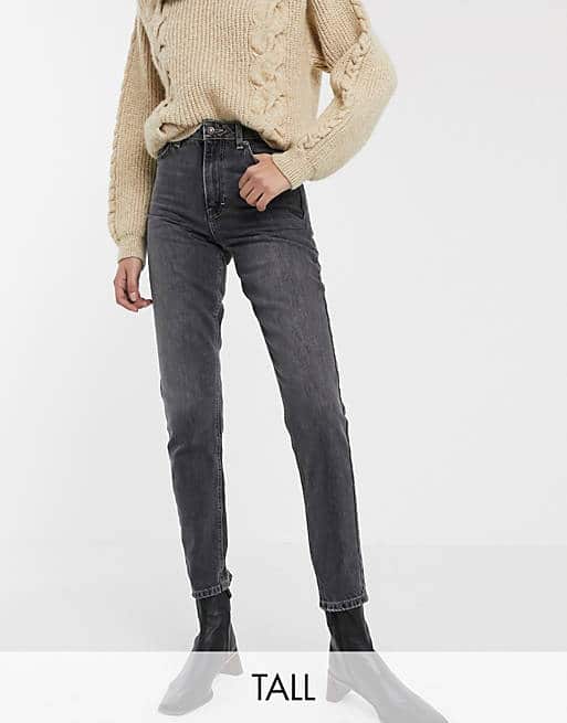 Dark grey high-waisted straight-leg jeans paired with a chunky cream sweater.