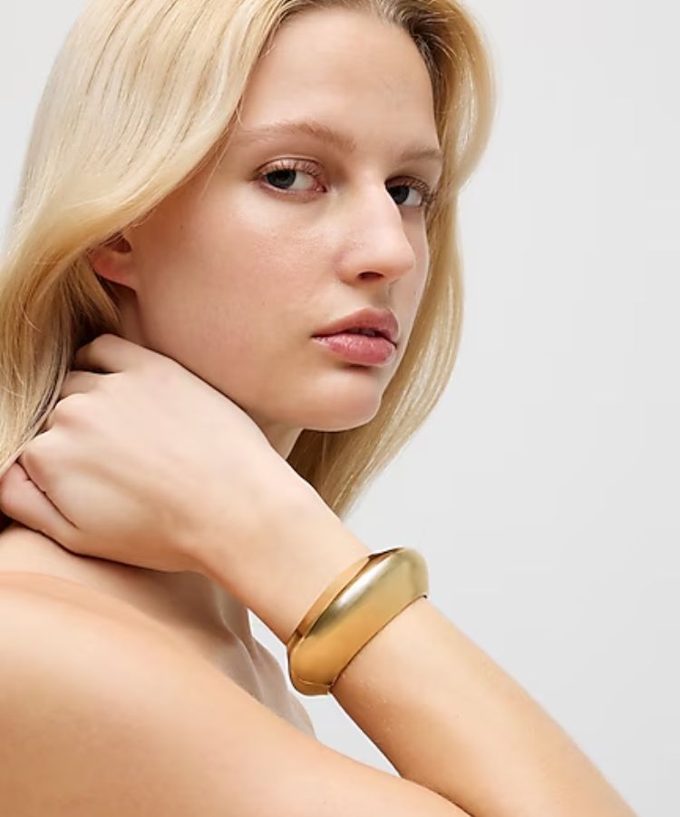A gold hinge cuff bracelet.