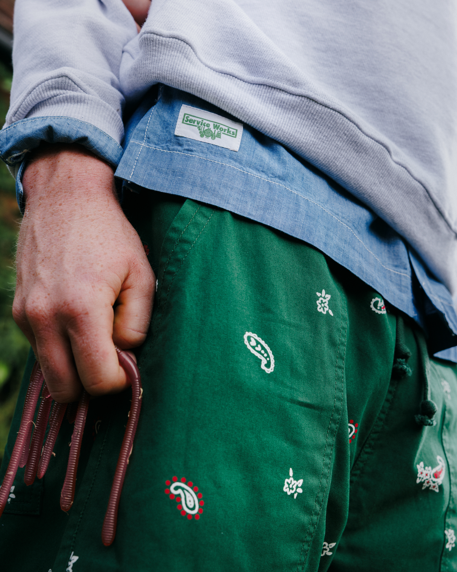 A person wearing classic houndstooth patterned chef pants paired with a black t-shirt.