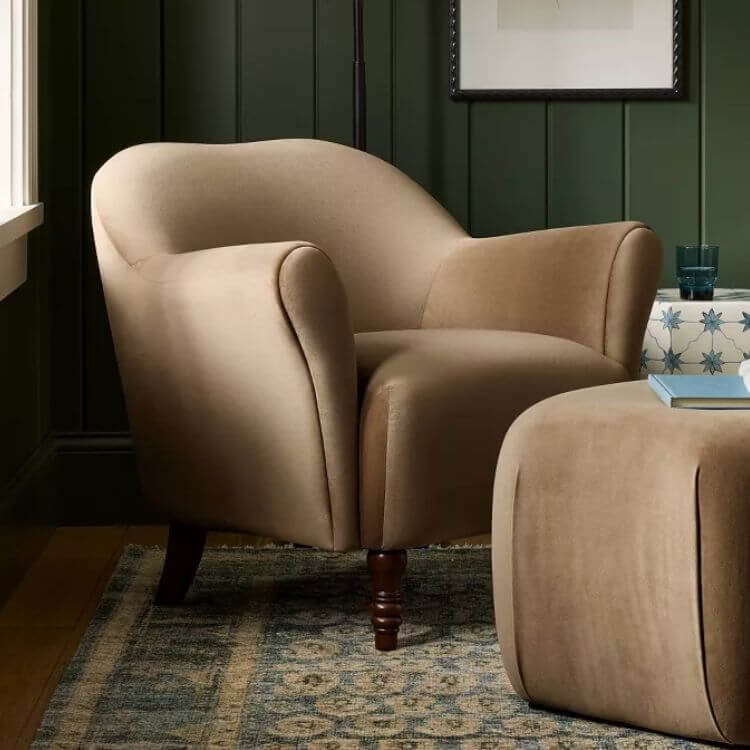 Green velvet accent chair with traditional turned wood legs.