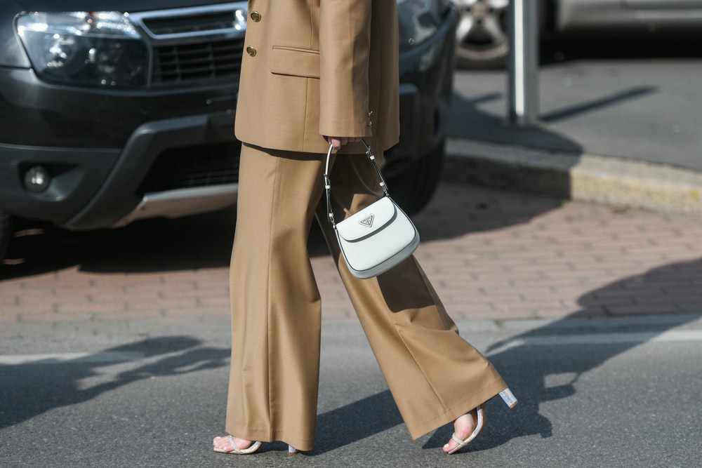 Full-length shot of a woman in a camel-colored wide-leg suit with matching heels.