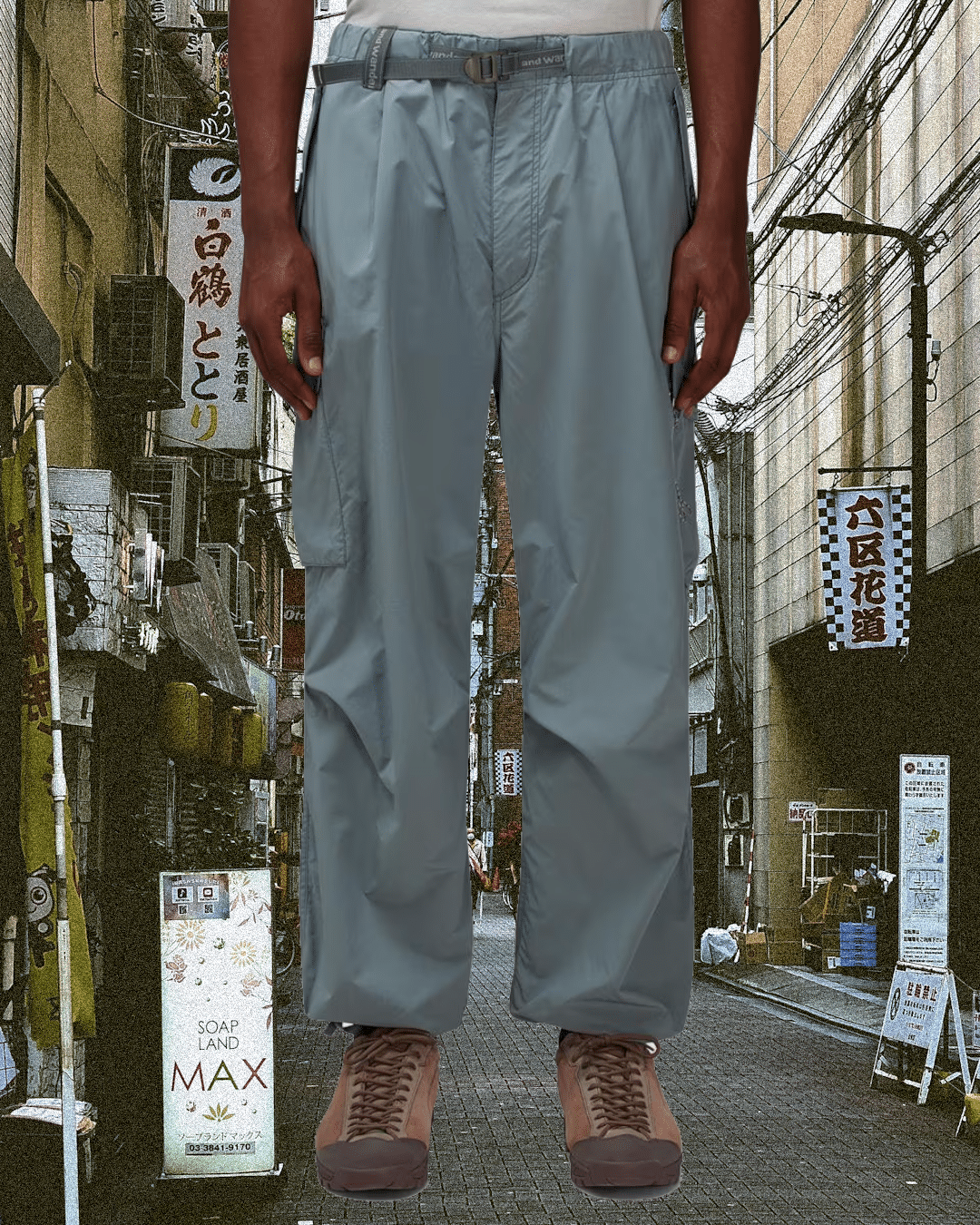 Person modeling light gray cargo pants in a traditional Japanese alleyway.