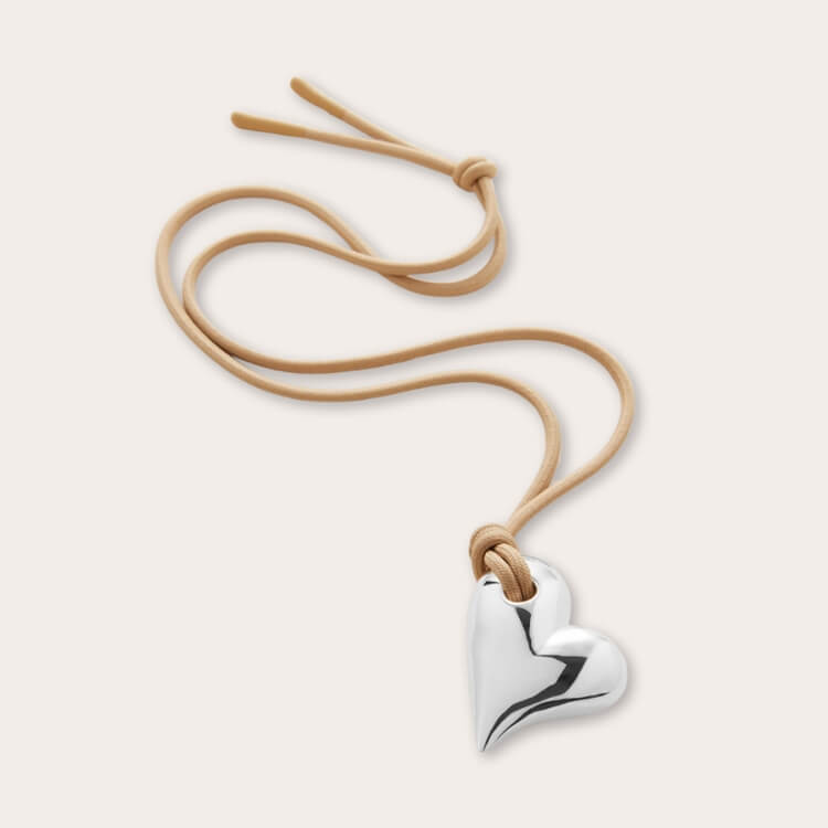 Close-up of a Jenny Bird Heart On a String Pendant Necklace in sterling silver.
