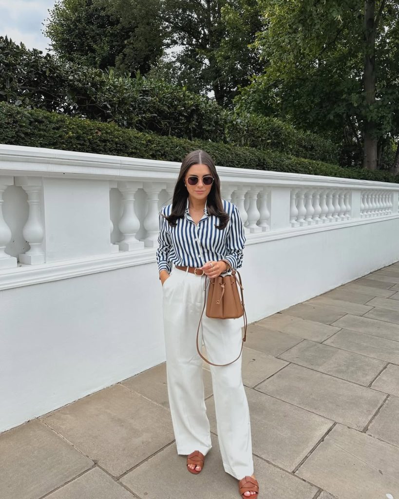 Detailed view of a tailored waistcoat paired with wide leg pants.