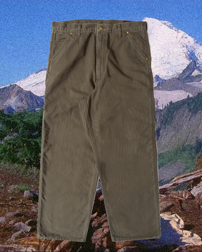 Olive green cargo pants with multiple utility pockets in an outdoor setting.