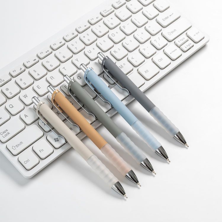 Set of minimalist white ballpoint pens with gold accents