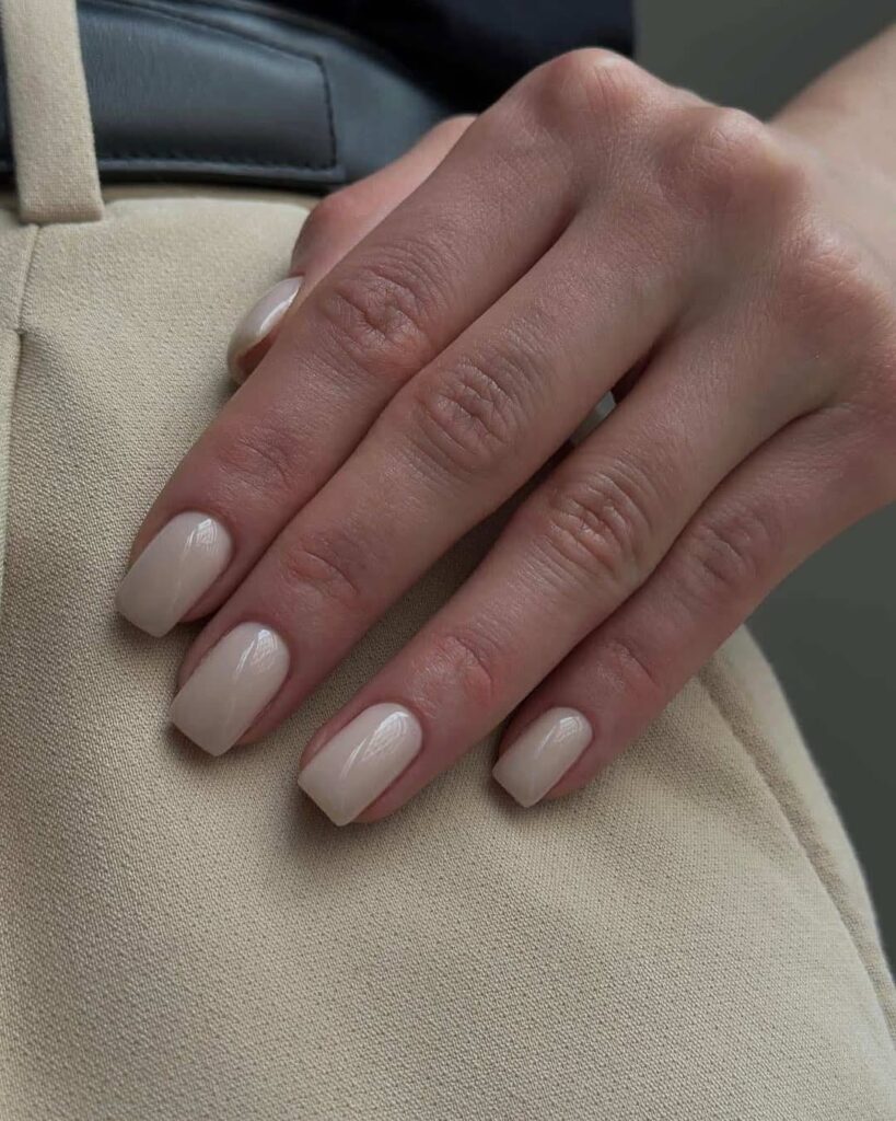 Neutral manicure with ultra-thin white micro-French tips.
