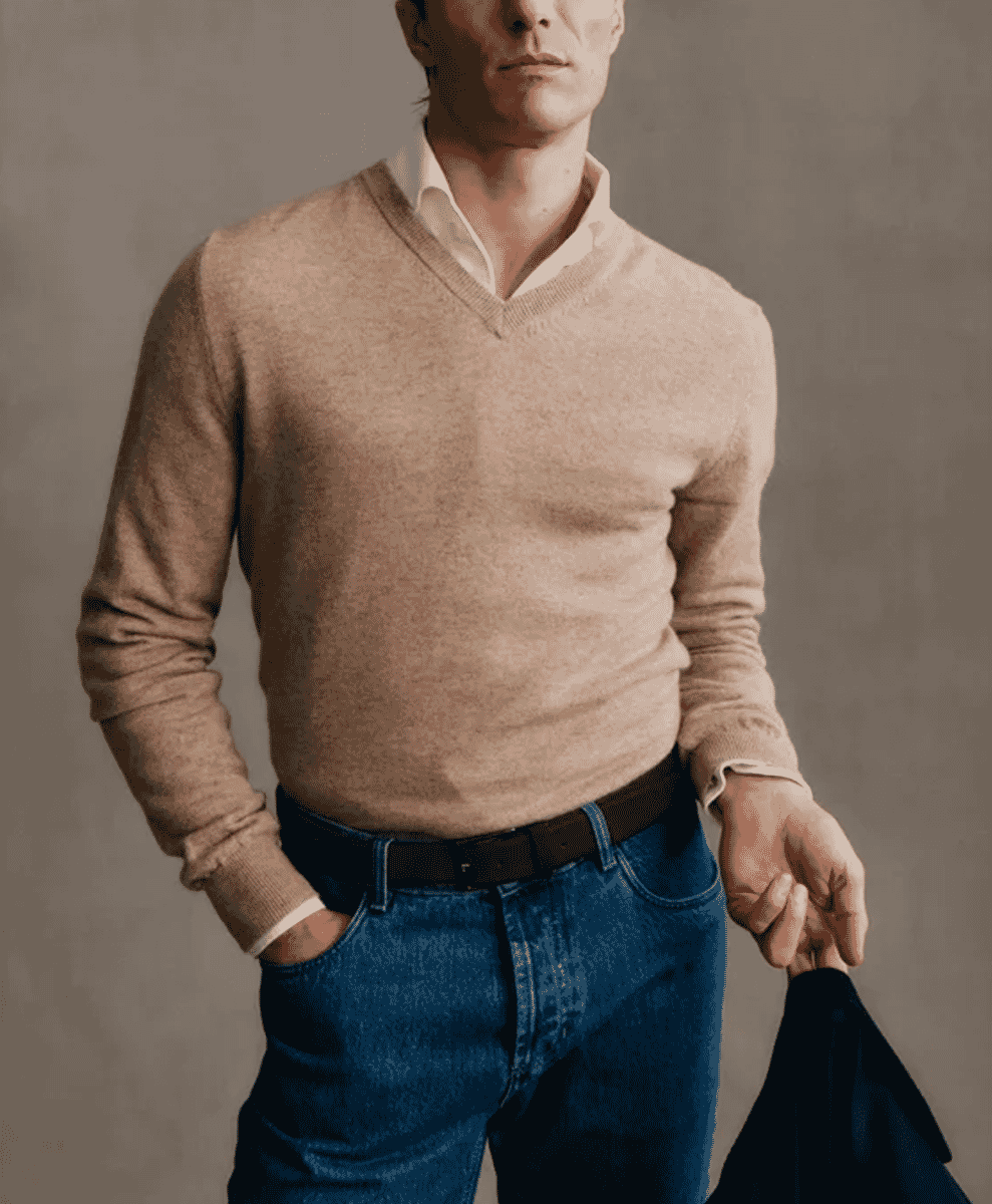 Man modeling a beige V-neck sweater over a white collared shirt.