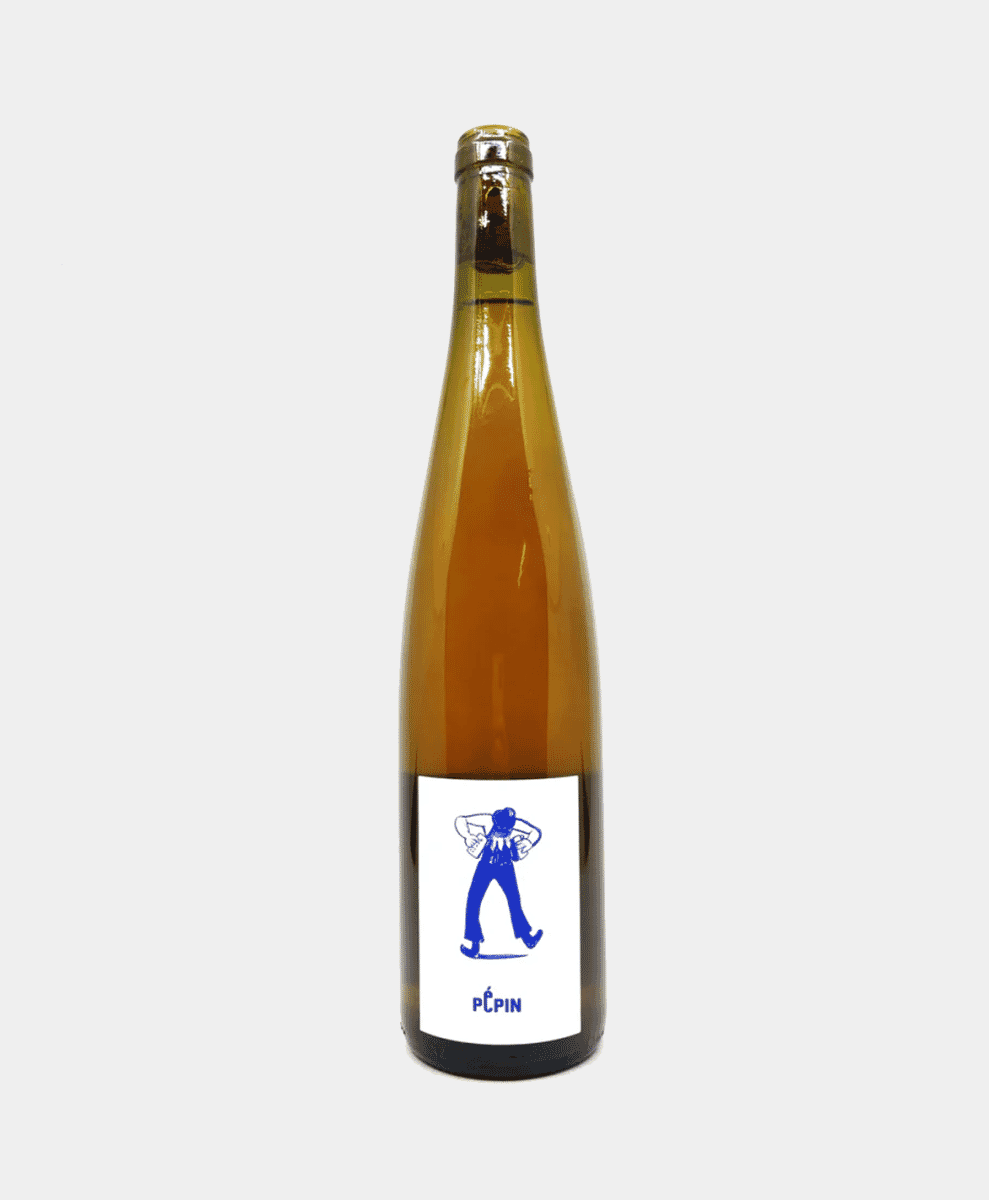 A bottle of Pépin Orange Wine on an outdoor table.