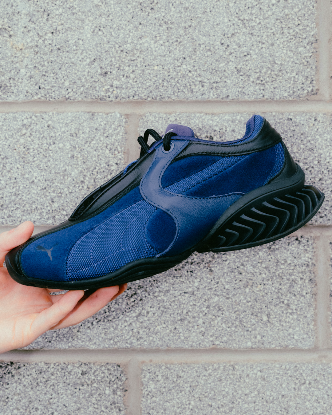Hero shot of the PUMA CELL Geo in a stylized, atmospheric environment.