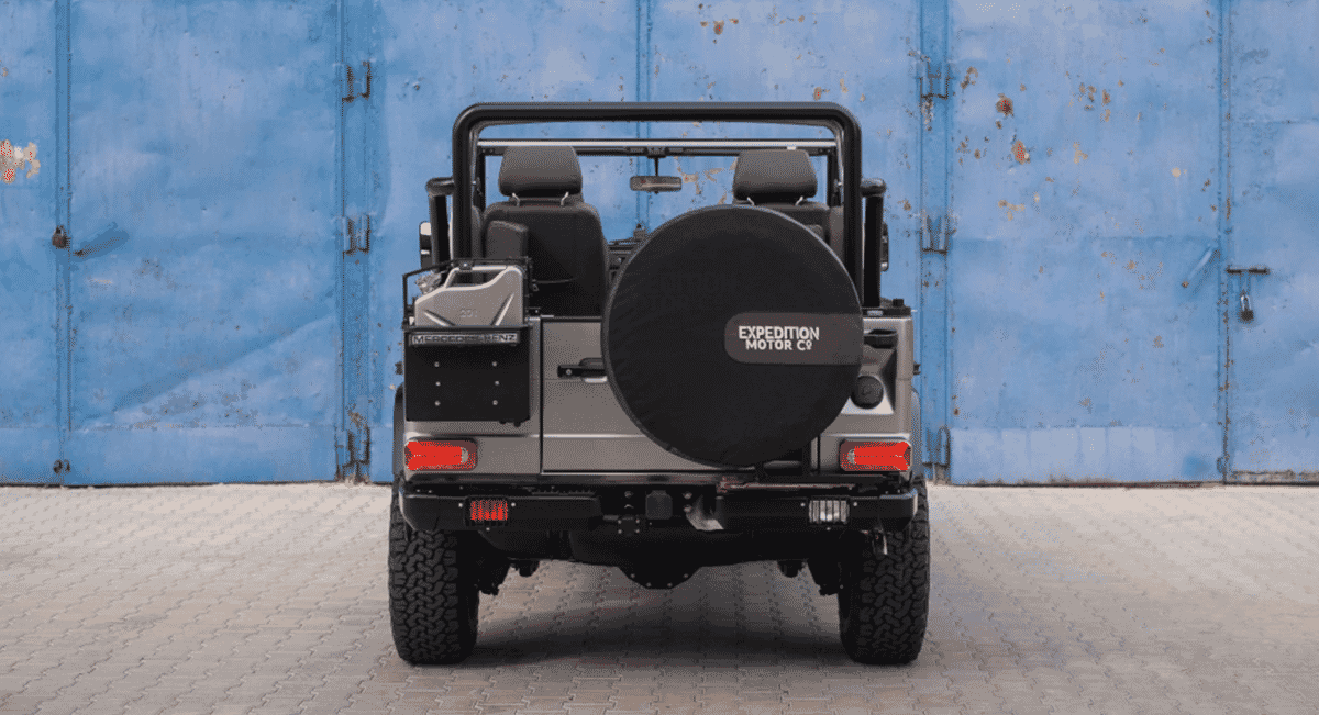 Rear view of a customized silver Mercedes-Benz G-Wagon featuring an Expedition Motor Co. spare tire cover.