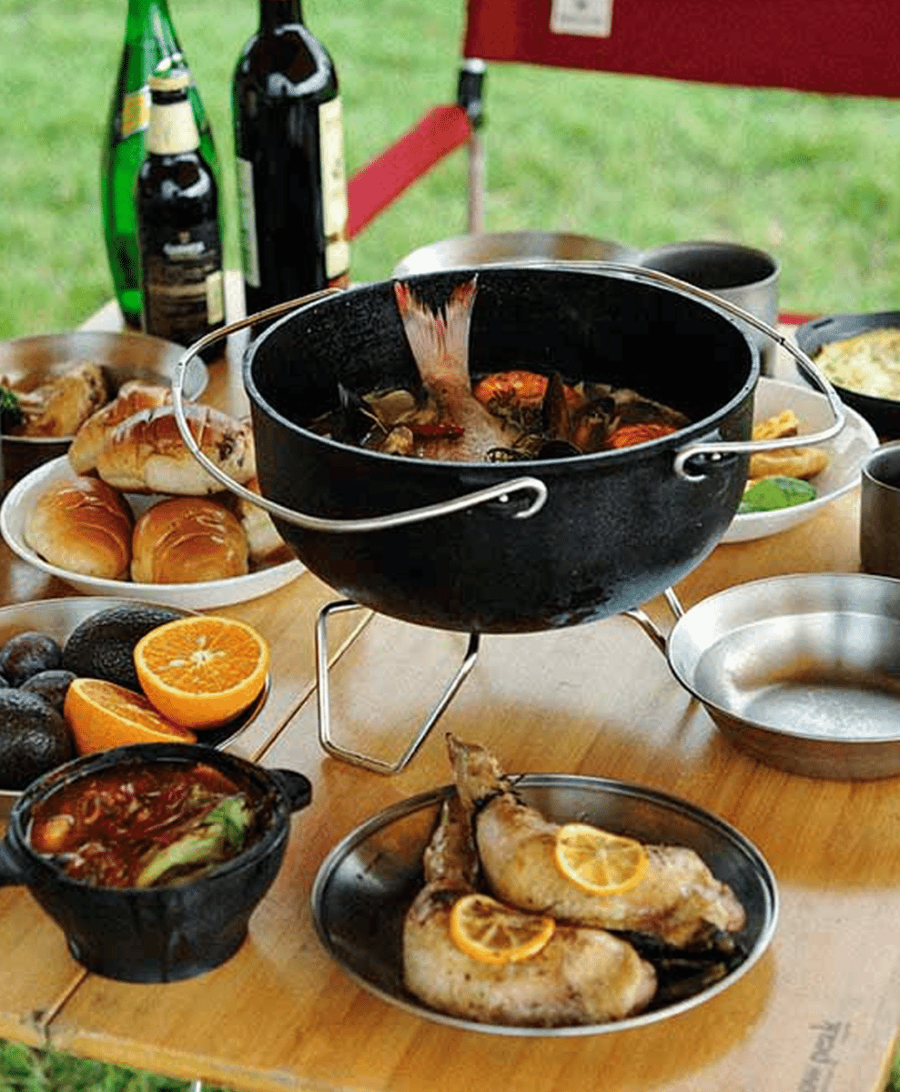 Snow Peak Cast Iron Oven positioned on an outdoor cooking station.