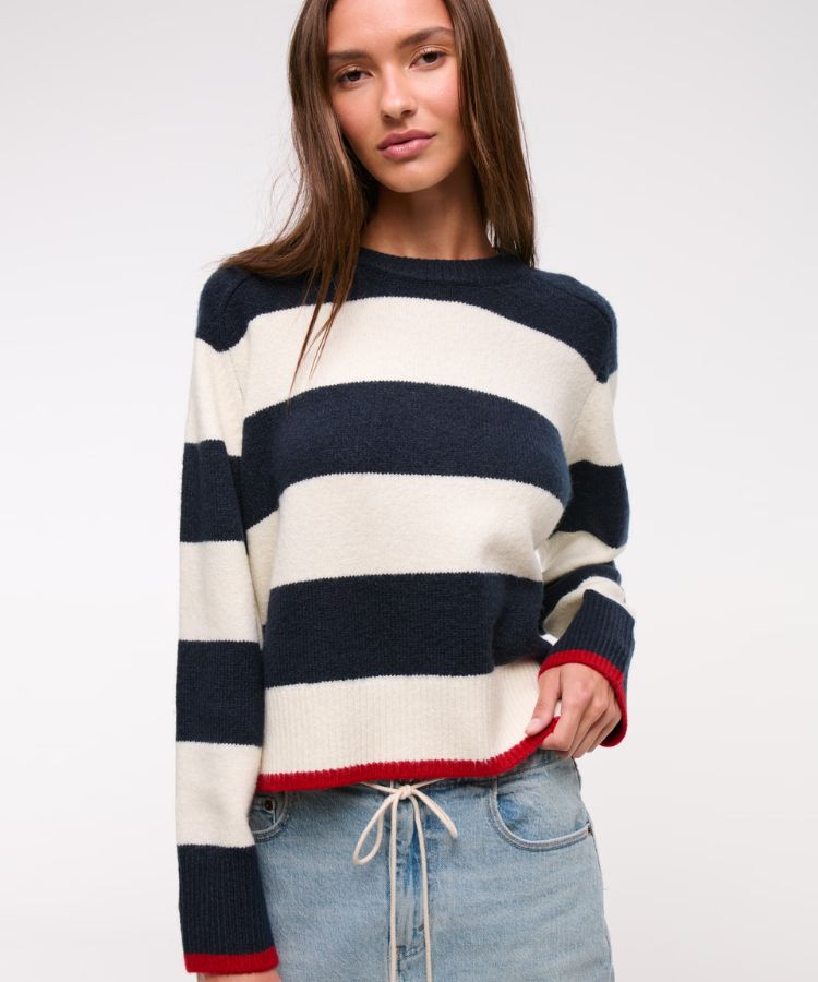 Striped black and white crew neck sweater in soft knit fabric.