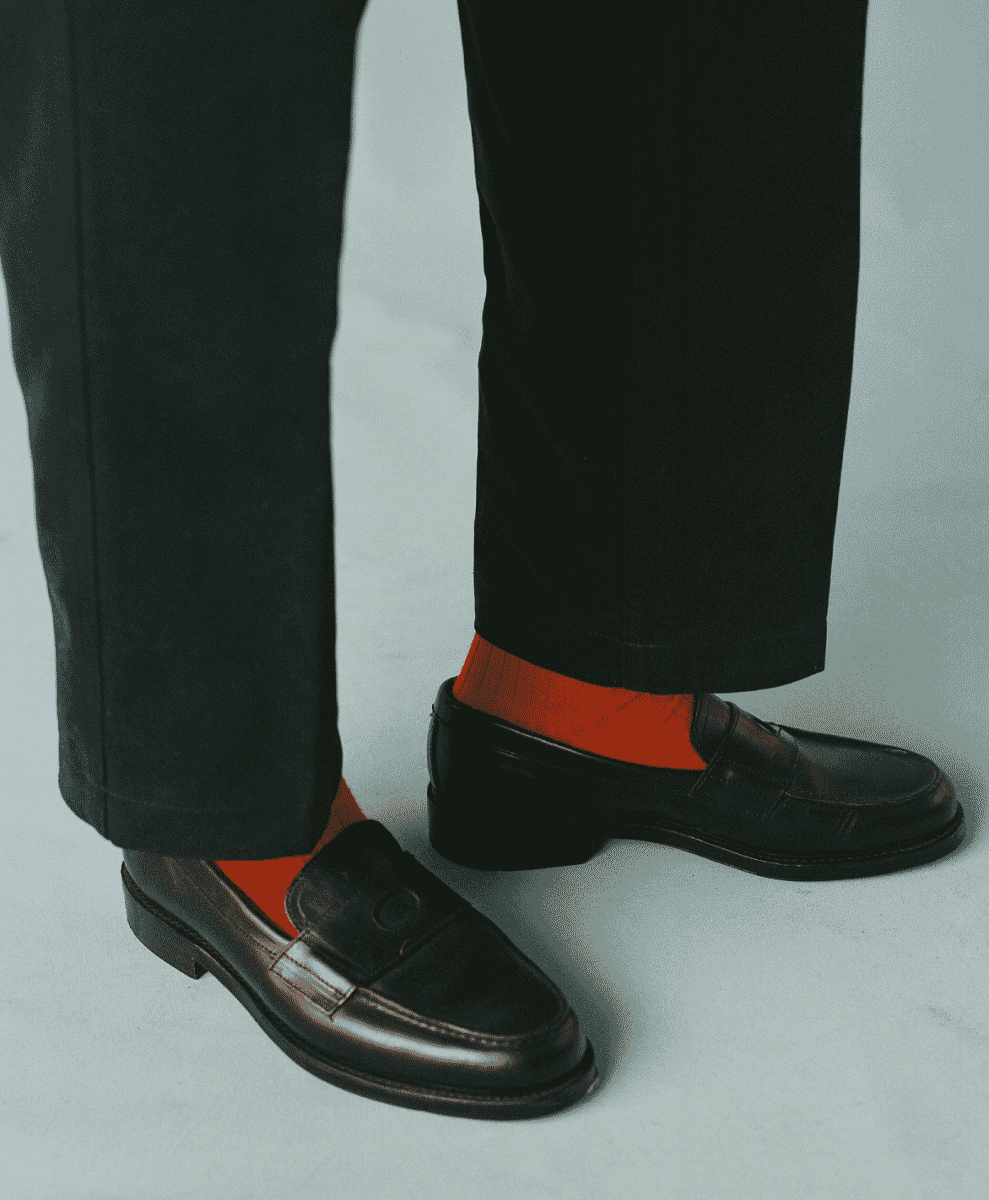 Black leather Charles Goodyear welted penny loafers.