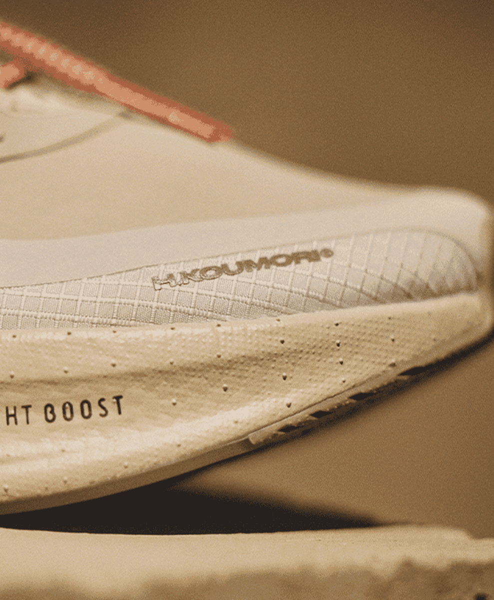 Close-up detail of the white Adidas UltraBOOST midsole featuring H.KOUMORI branding.