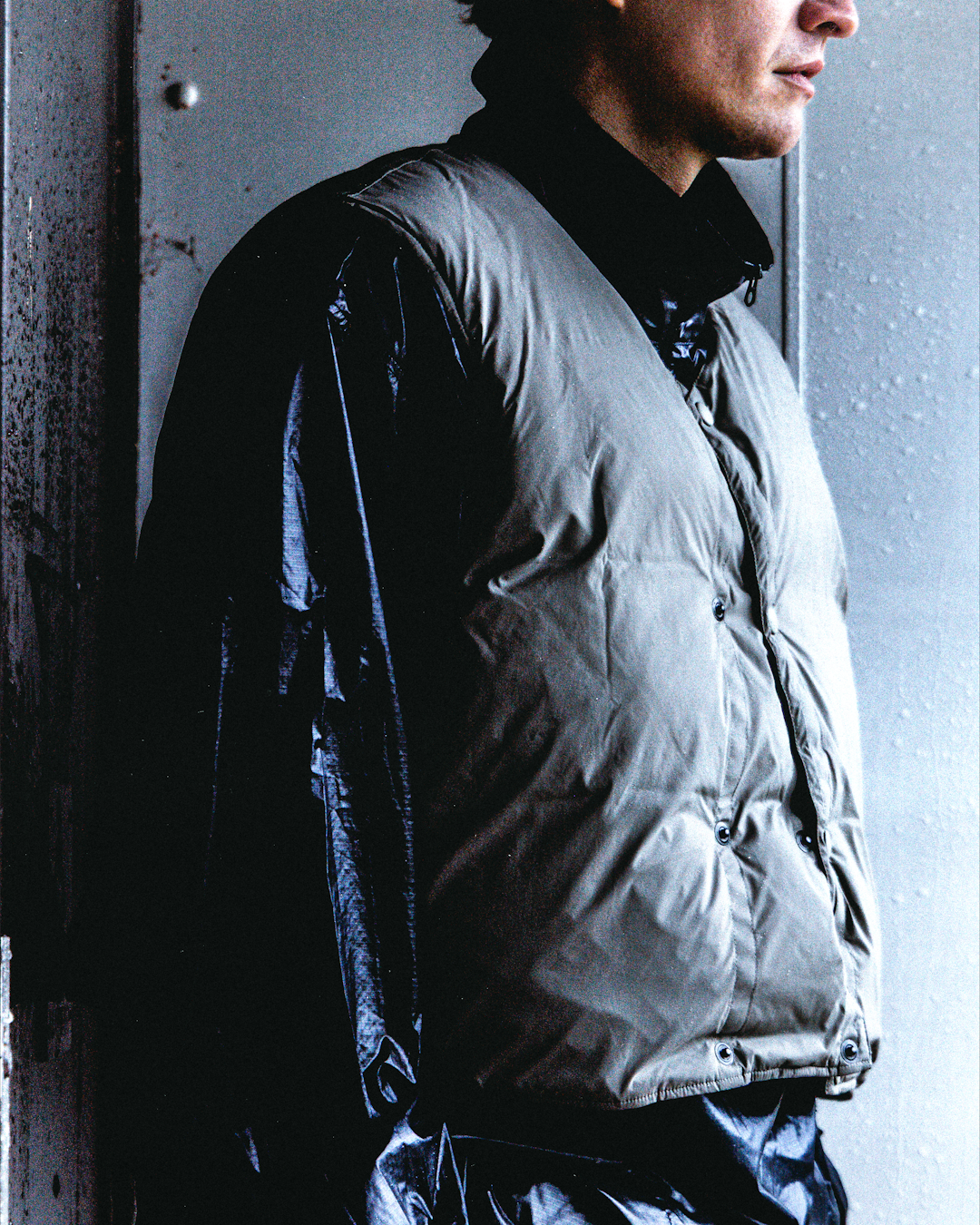 Extreme close-up of a taped seam and waterproof zipper on a technical jacket.