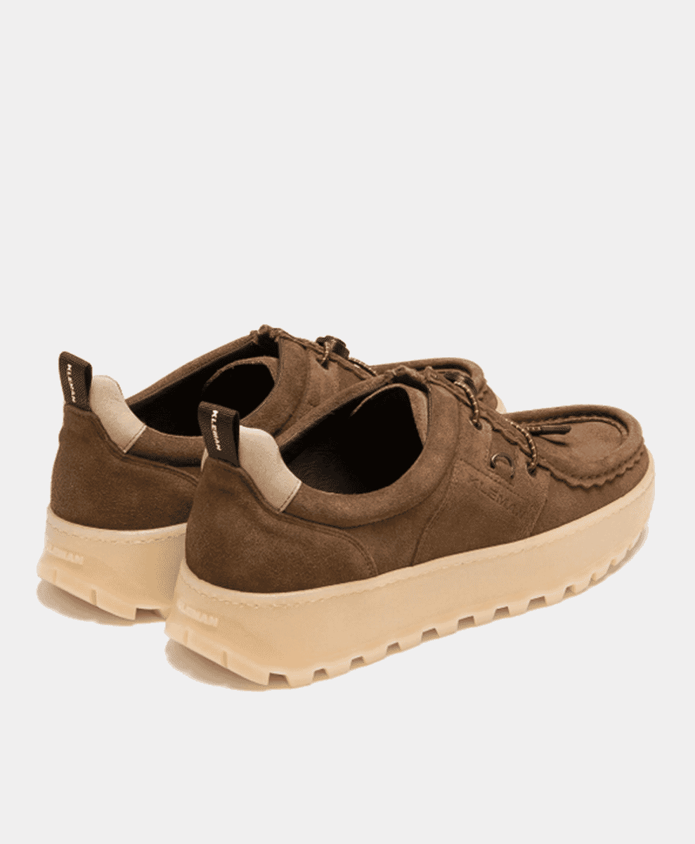 Rear view of brown suede sneakers with chunky soles on a white background.