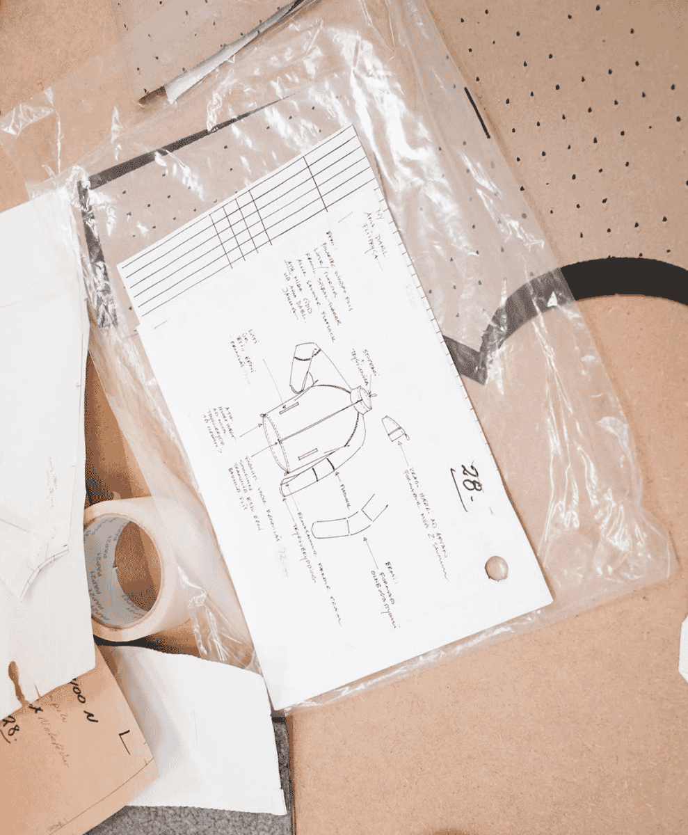 A detailed technical garment sketch for a jacket with measurements and annotations.