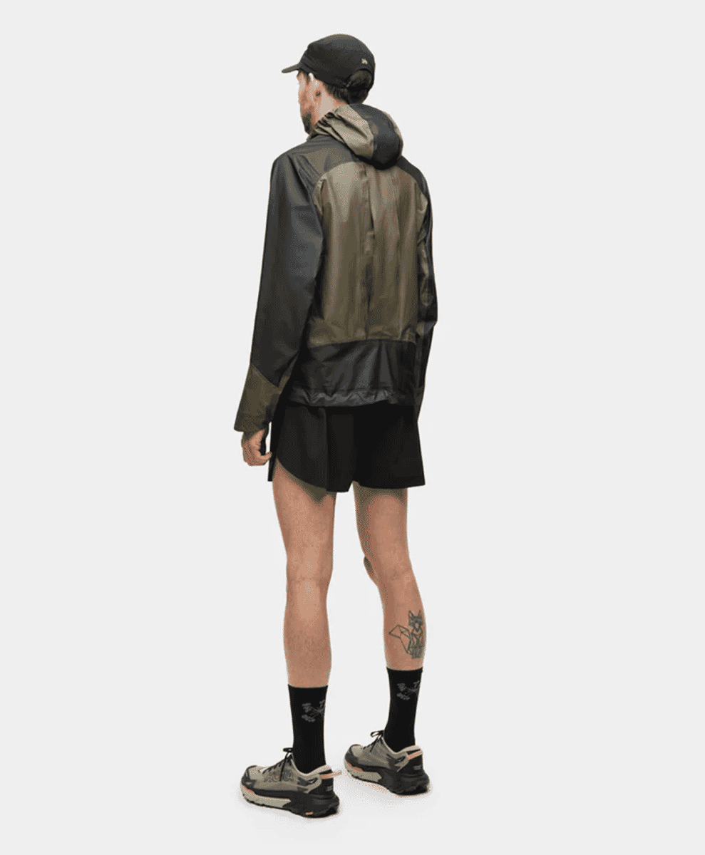 Back view of the jacket showing the pleated panel expanding to accommodate a running vest.