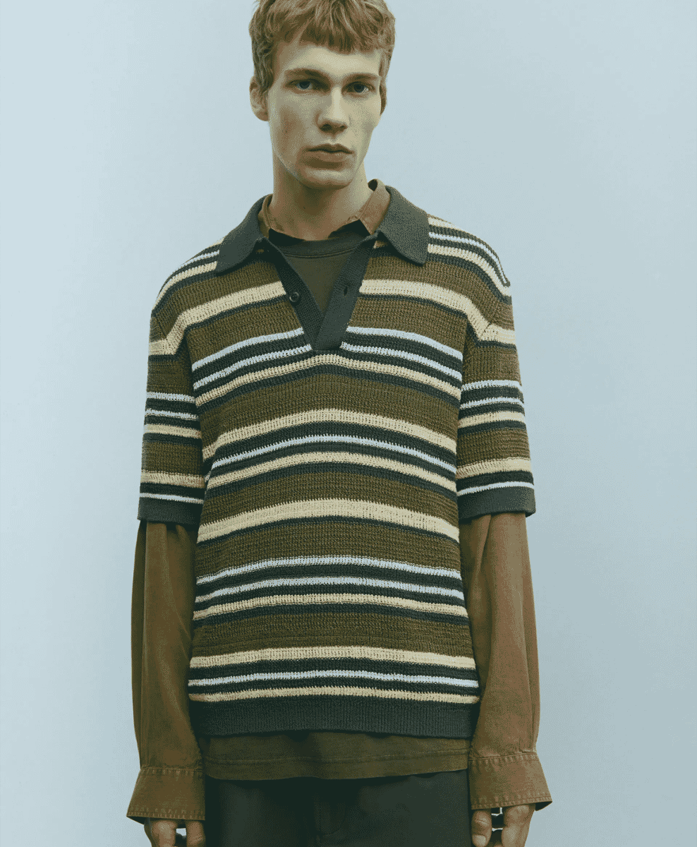 A man wearing a classic crew neck sweater in a vibrant yet versatile hue.