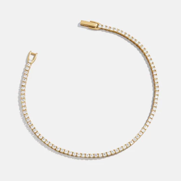 A classic sparkling tennis bracelet with 18k gold plating.