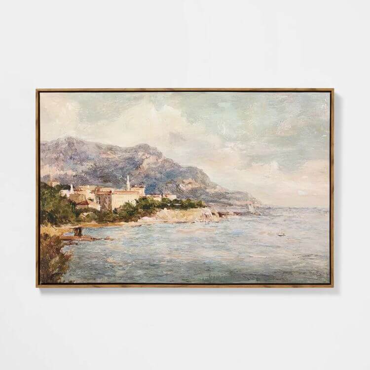 Framed coastal landscape wall art with soft blues and neutral tones.