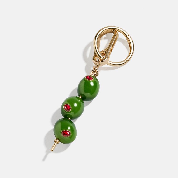 A playful olive-shaped bag charm with crystal accents.