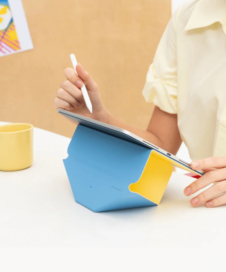 An iPad in a raised, ergonomic landscape position using an origami-style stand.