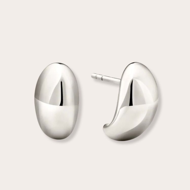 Mejuri Dome Huggies in silver showing a thick, rounded design.