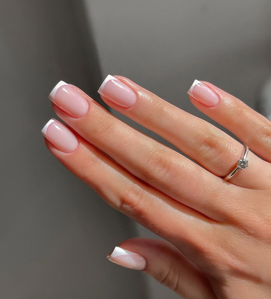 Milky white almond-shaped nails with a polished, opaque finish.