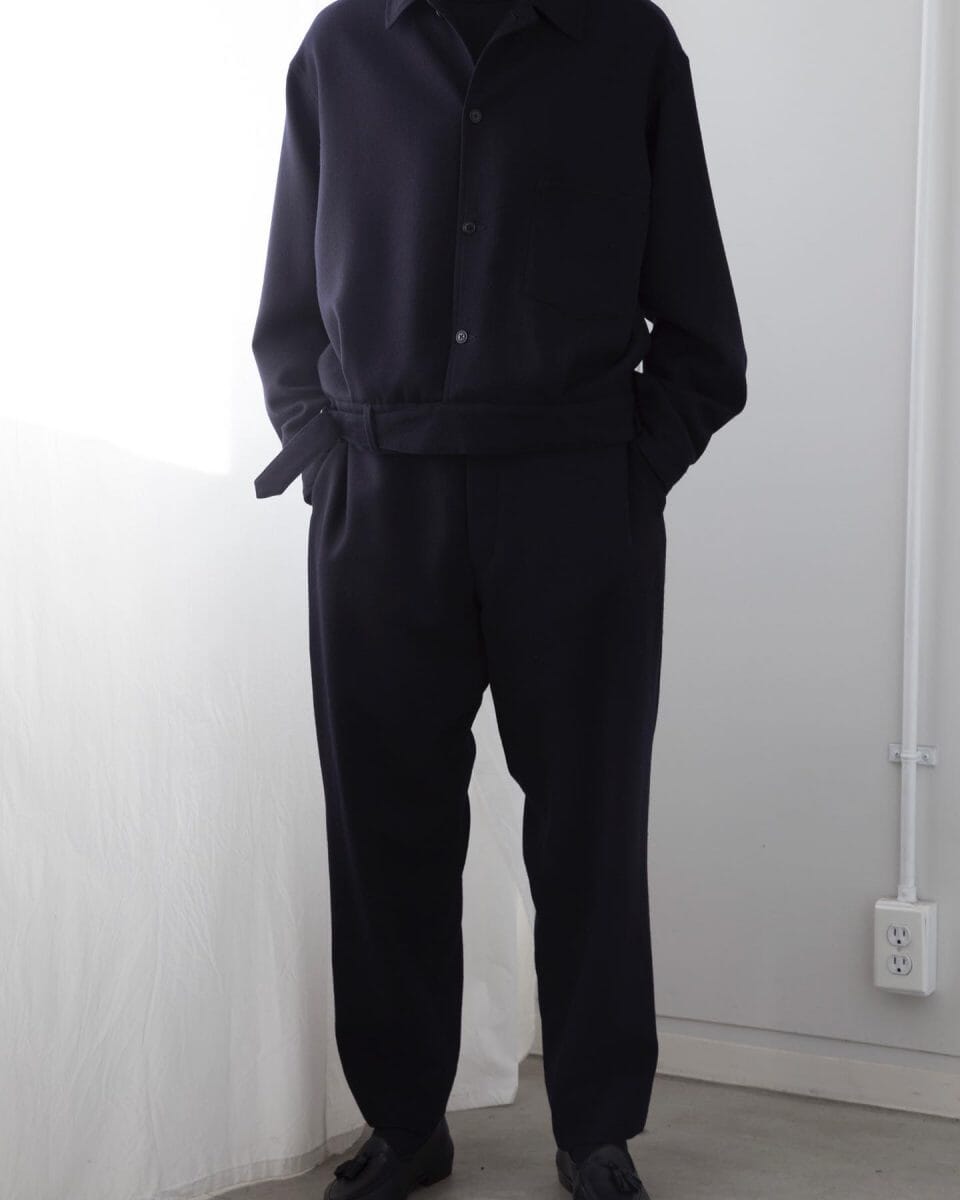 Minimalist menswear styling from COMOLI featuring relaxed fit trousers and jacket.