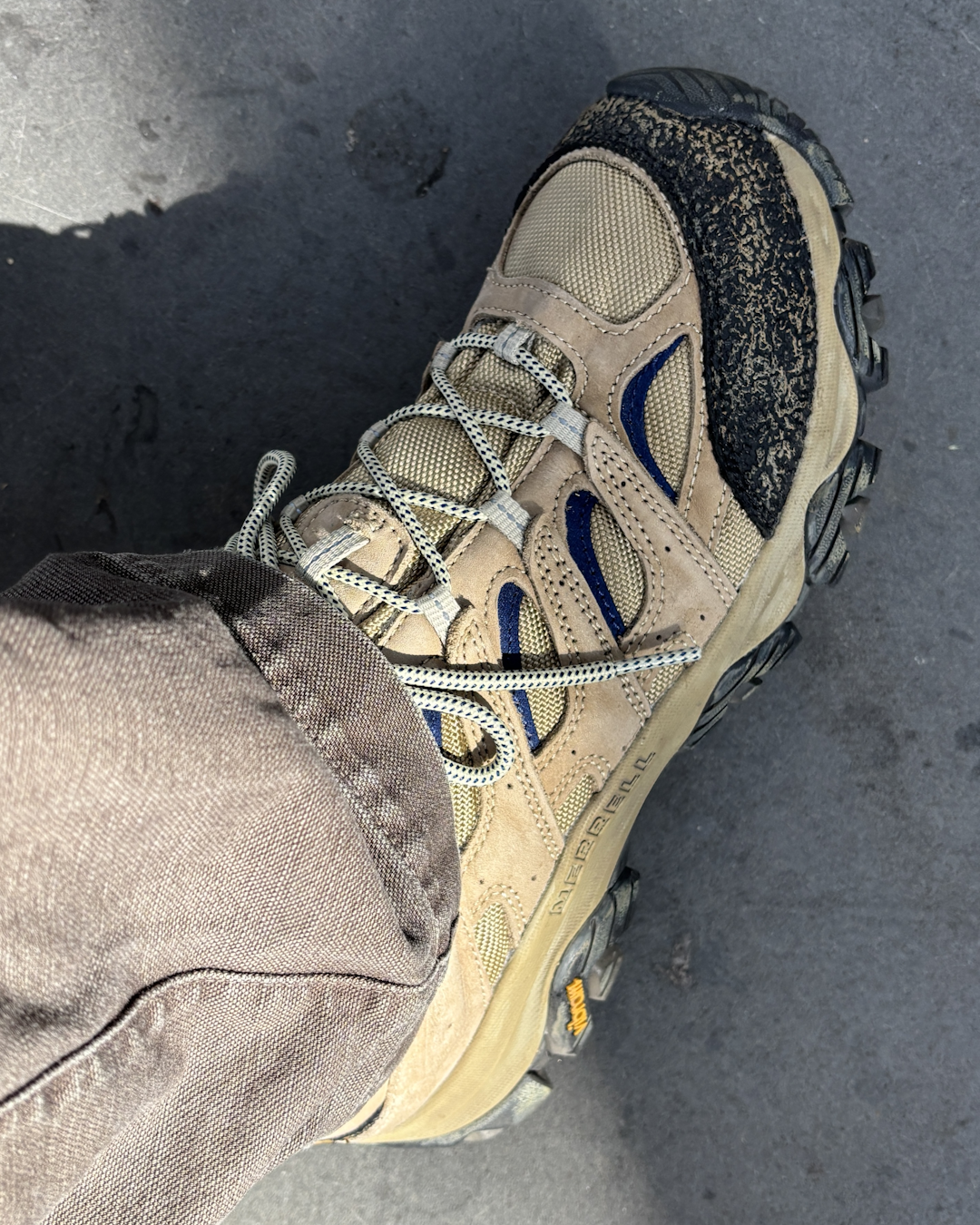 The Khakis x Merrell Moab 3 shoes in a messy, outdoor environment showing light trail dust.